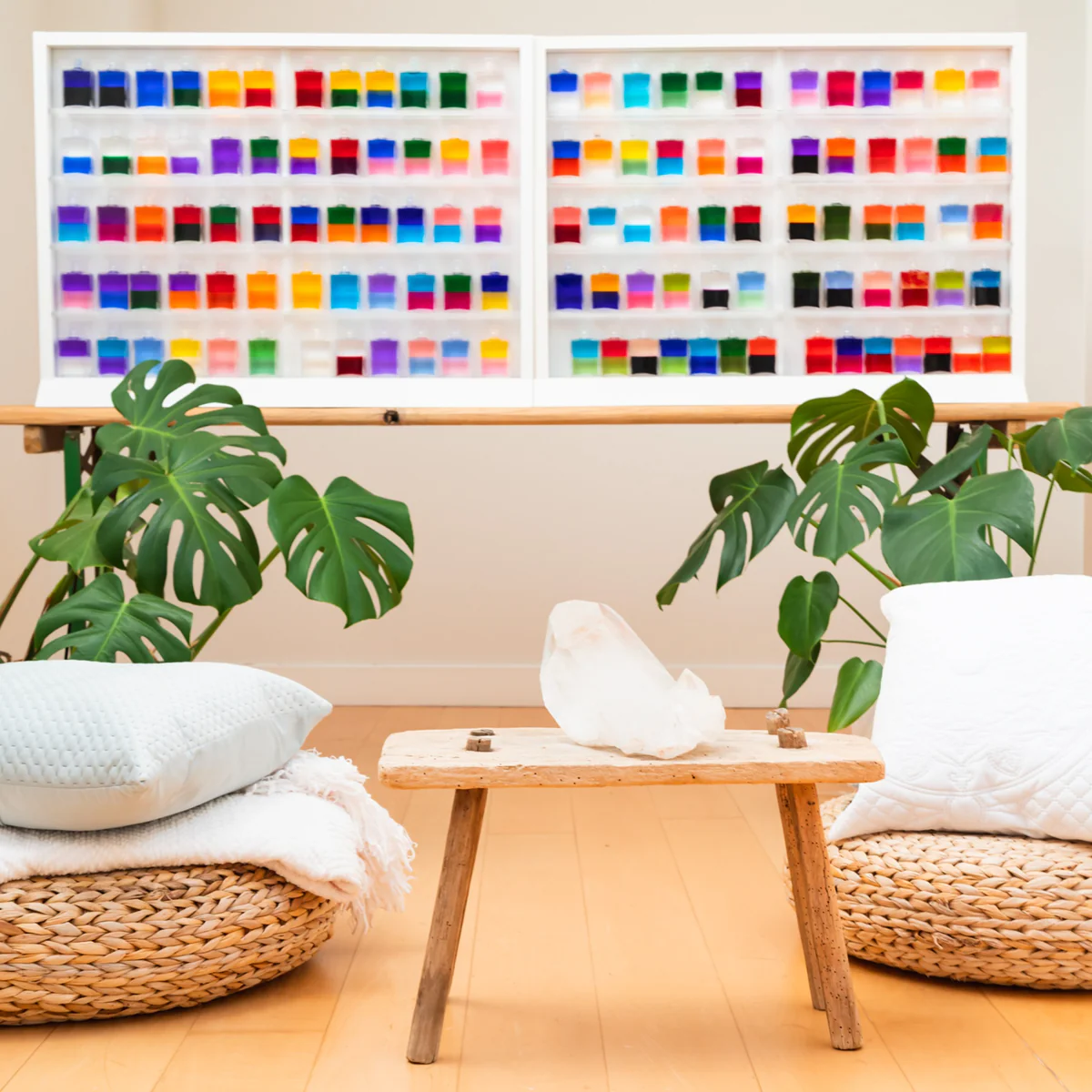A serene therapy room with a large collection of Aura-Soma bottles on display.